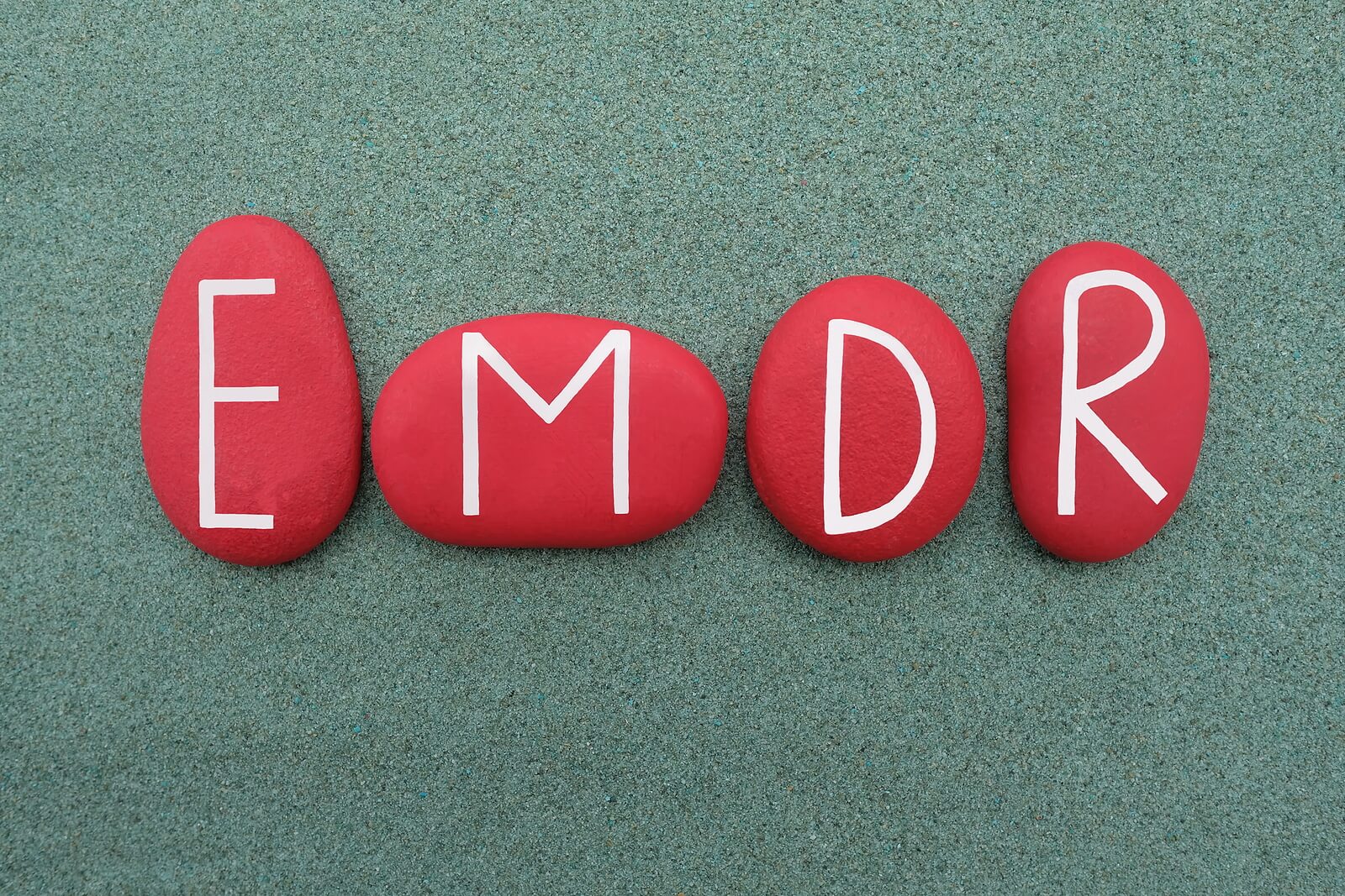 EMDR painted on red rocks. With EMDR counseling in Cypress, TX can help with past trauma. Get started today with a trauma therapist!
